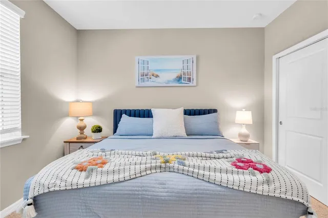 a bedroom with a large bed and a lamp