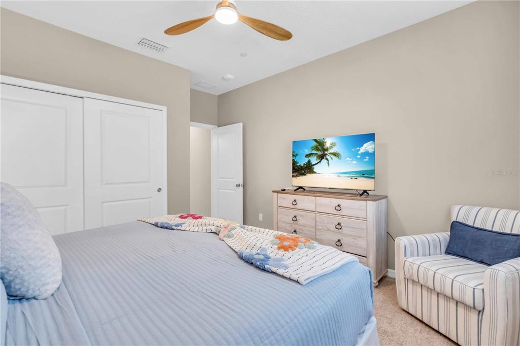 12413 Osorio Court, Unit 101 Sarasota, FL 34238 - Photo 32 of 46 a bedroom with a bed and a dresser