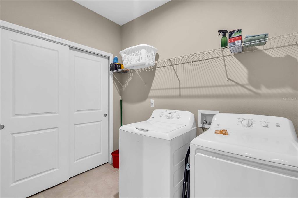 12413 Osorio Court, Unit 101 Sarasota, FL 34238 - Photo 33 of 46 a utility room with dryer and washer