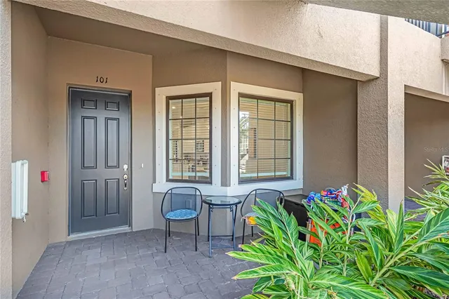 a view of front door with chair and table