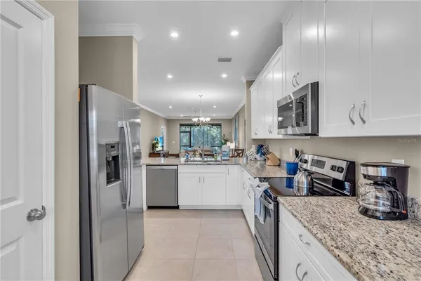 a kitchen with refrigerator and cabinets