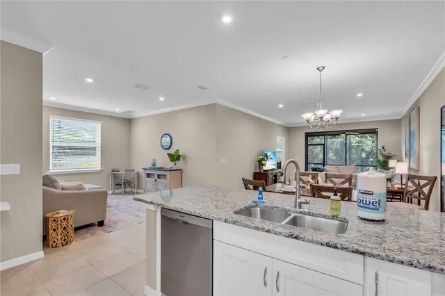 a kitchen with sink refrigerator and window