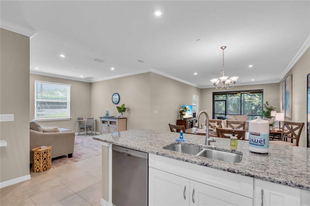 12413 Osorio Court, Unit 101 Sarasota, FL 34238 - Photo 9 of 46 a kitchen with sink refrigerator and window