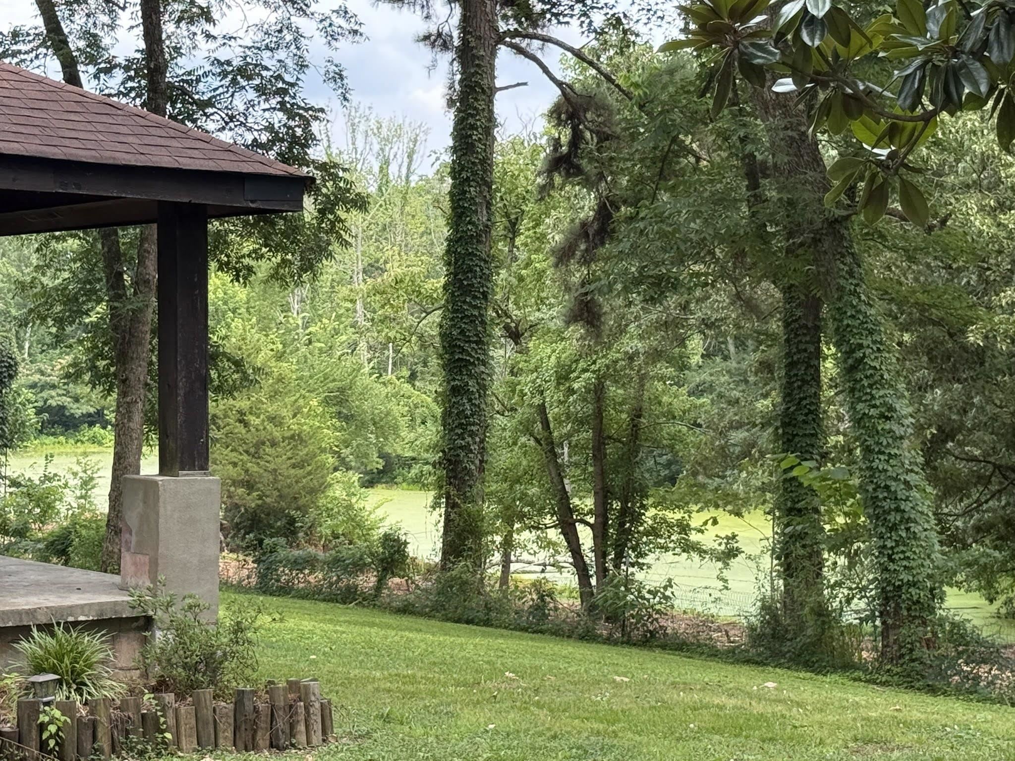 6760 Locke Road Millington, TN 38053 - Photo 32 of 39 Covered outdoor structure featuring a brown shingle roof and substantial support posts