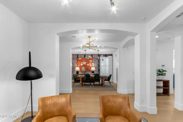 a kitchen with stainless steel appliances a refrigerator a stove and white cabinets