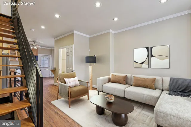 a living room with furniture a rug and a large window