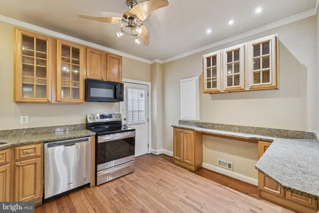 a kitchen with stainless steel appliances granite countertop a stove and a sink