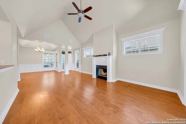 a view of empty room with wooden floor and fireplace