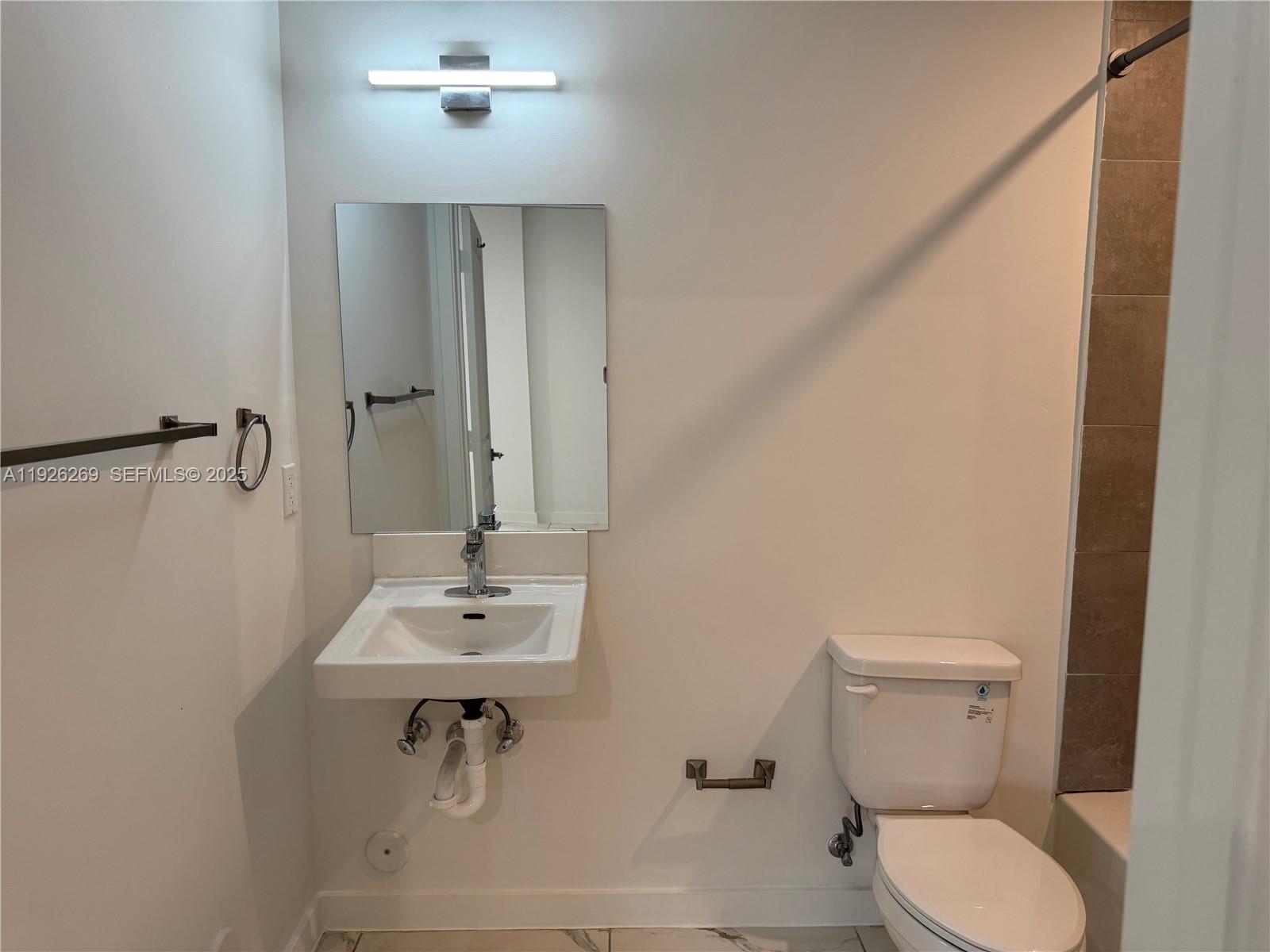 420 Southwest 7th Avenue, Unit 101 Miami, FL 33130 - Photo 14 of 16 a bathroom with a sink a toilet and shower