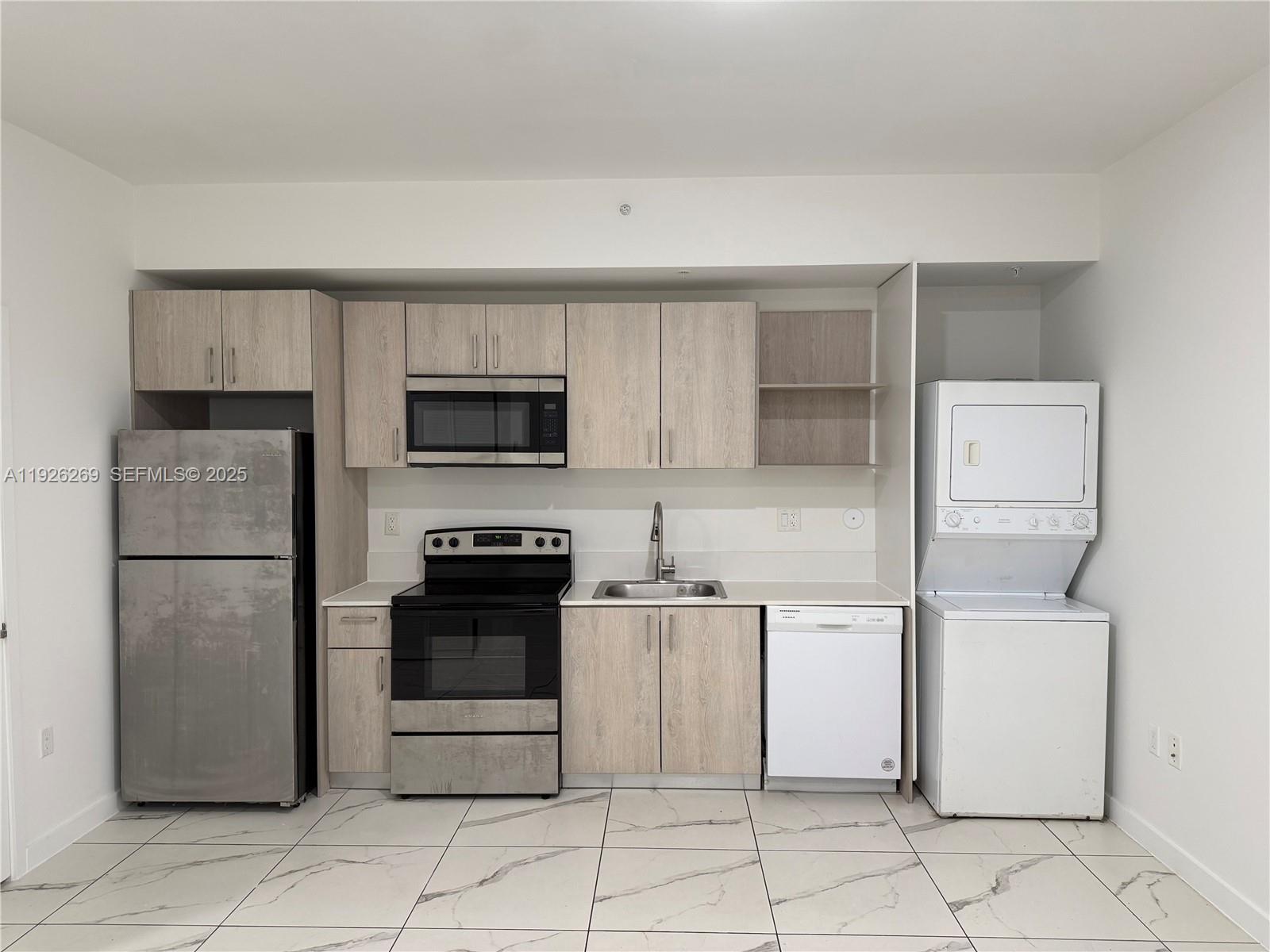 420 Southwest 7th Avenue, Unit 101 Miami, FL 33130 - Photo 4 of 16 a kitchen with stainless steel appliances granite countertop a stove and a refrigerator