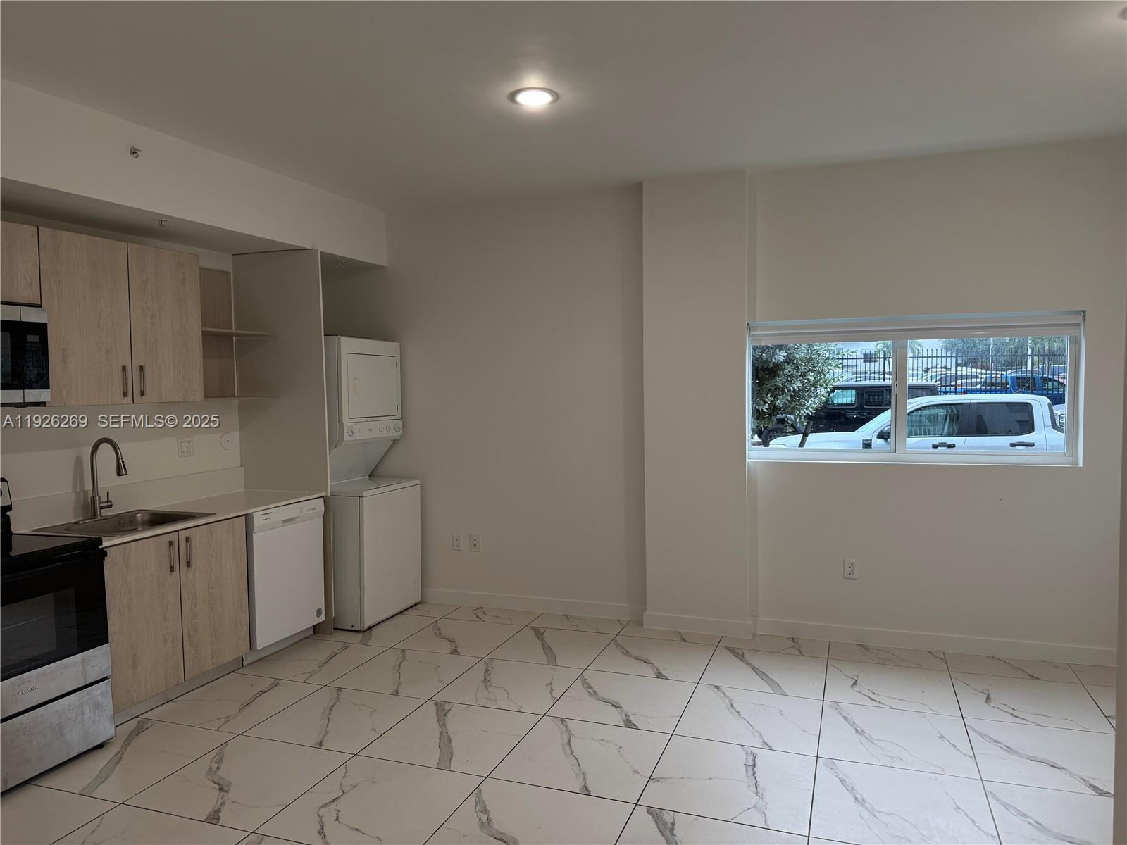 420 Southwest 7th Avenue, Unit 101 Miami, FL 33130 - Photo 6 of 16 a kitchen with white cabinets and window