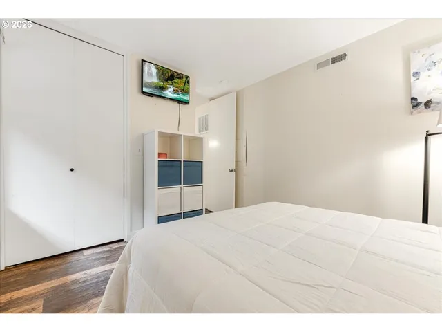 a bedroom with a bed and a window