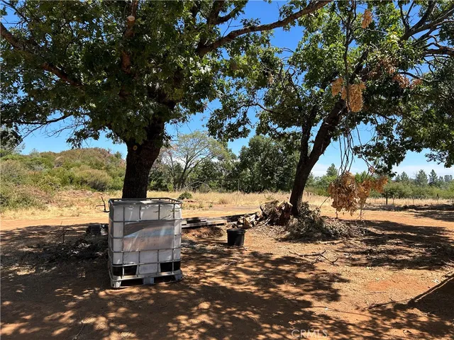 a view of a dirt road with a building in the background