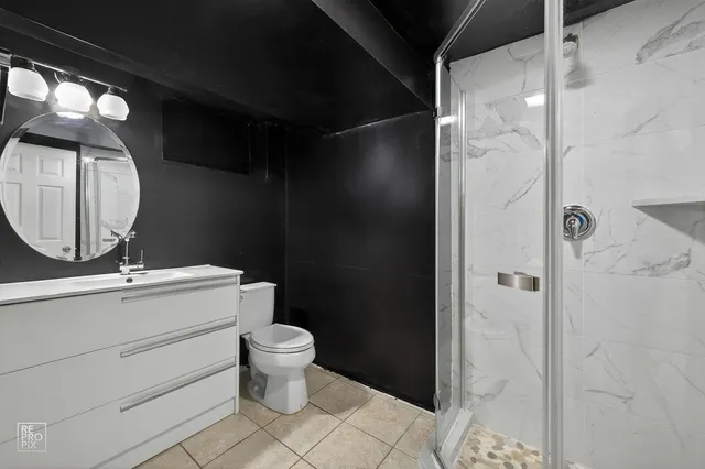 a bathroom with a toilet sink and shower