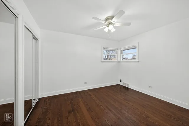 a view of a room with wooden floor and white walls