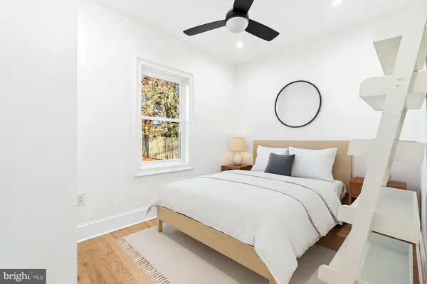 a bedroom with a large bed and chandelier