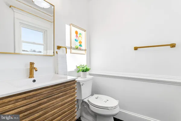 a bathroom with a sink a toilet and mirror