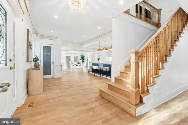 a bedroom with a large bed a lamp and windows