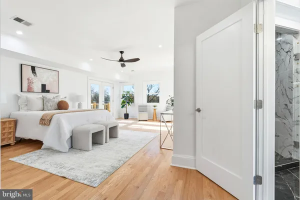a bathroom with a granite countertop sink a mirror a vanity and next to a window