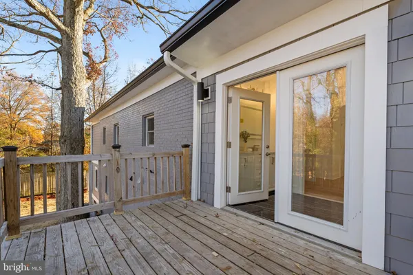 a view of a balcony with wooden floor and fence