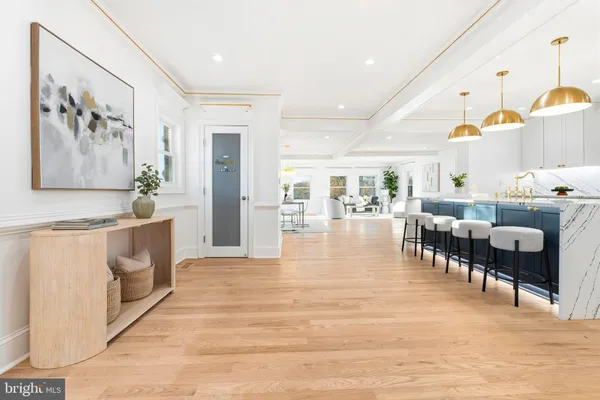 a dining hall with stainless steel appliances granite countertop a stove and a refrigerator