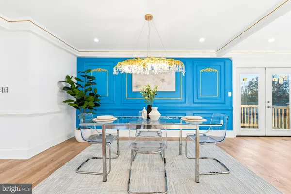 a dining room with furniture and a potted plant