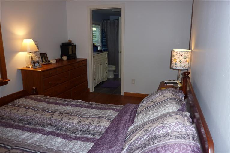 34 Wolley Road Hyannis, MA 02601 - Photo 16 of 19 a bedroom with a bed and a lamp on dresser