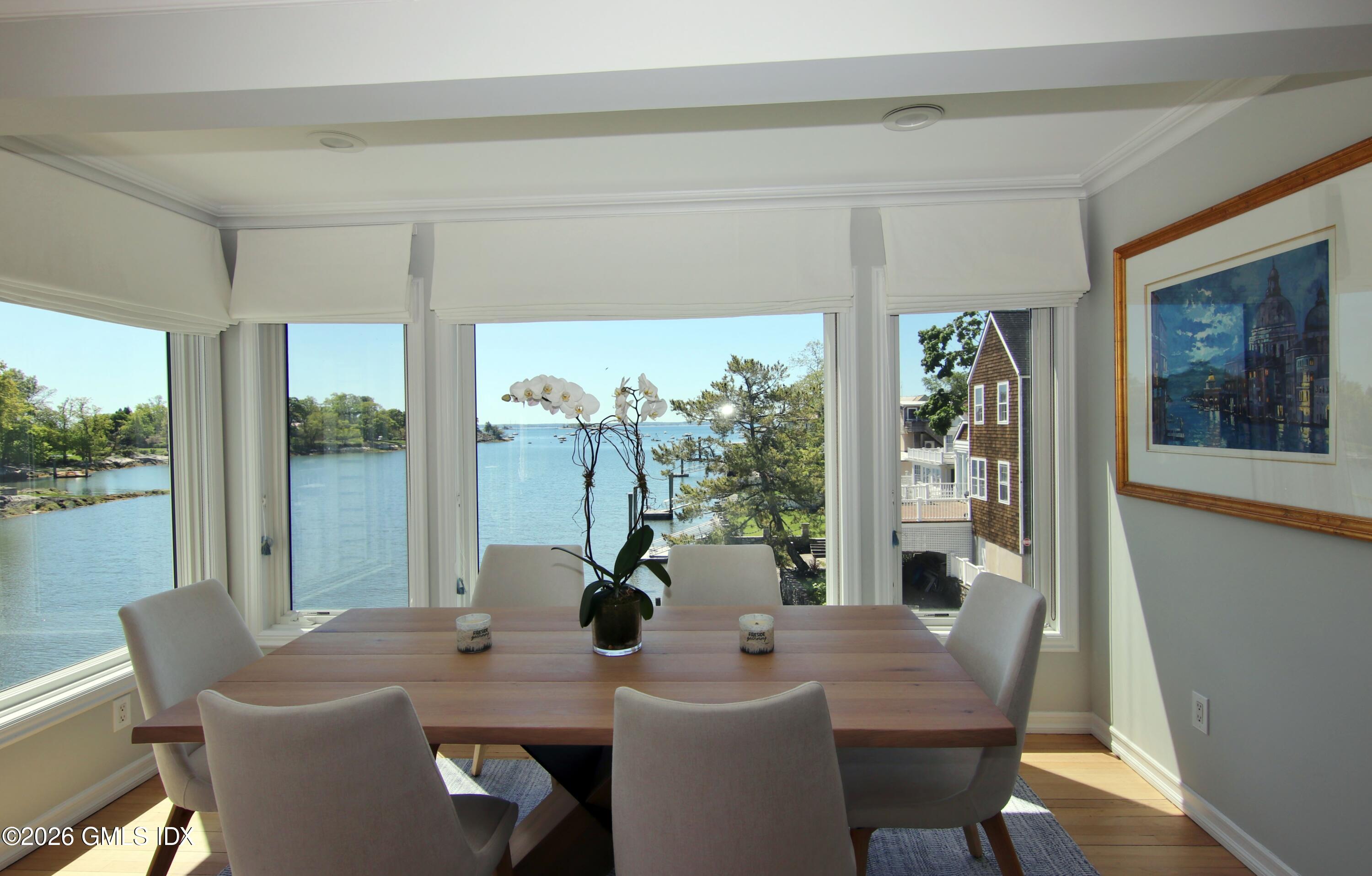 633 Steamboat Road, Unit 5 Greenwich, CT 06830 - Photo 20 of 29 a view of a dining room with furniture large windows and wooden floor