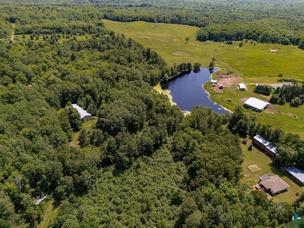 2592 Strandberg Road Barnum, MN 55707 - Photo 41 of 44 Expansive acreage featuring dense woodlands, open fields, a private pond, and multiple outbuildings