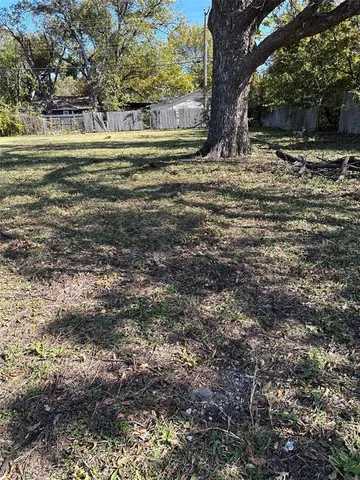 a view of a yard with large trees