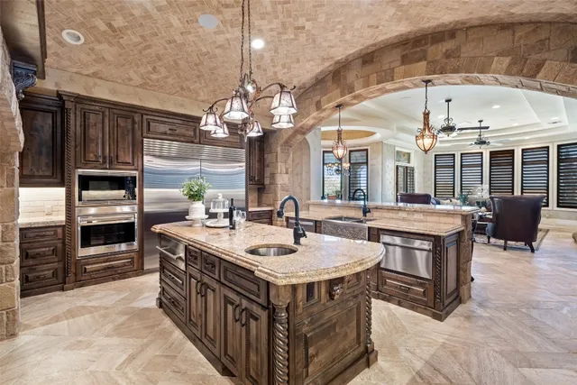 a kitchen with stainless steel appliances granite countertop a sink and a stove