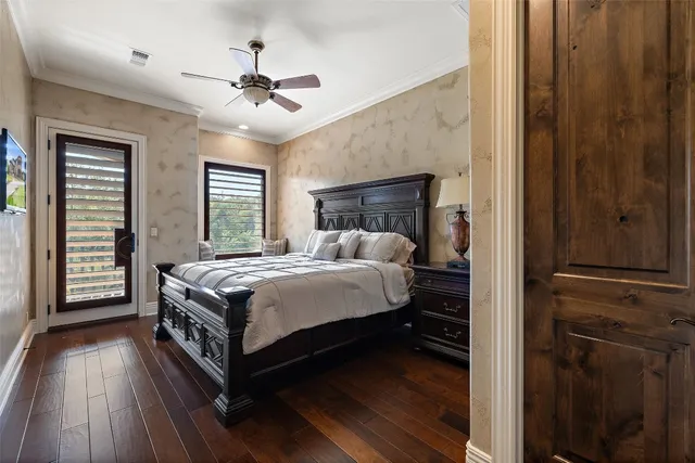 a bedroom with a bed and a dresser with wooden floor