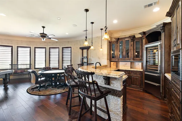 a large kitchen with a table and chairs