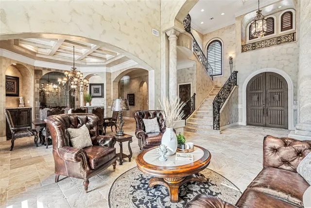 a living room with furniture a fireplace and a dining table with wooden floor