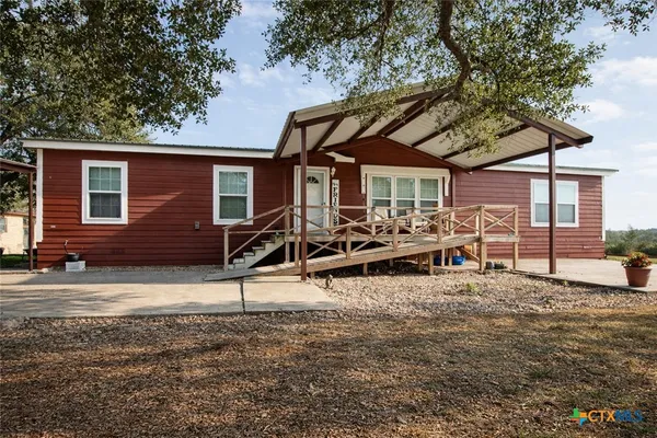 a view of a house with backyard porch and sitting area