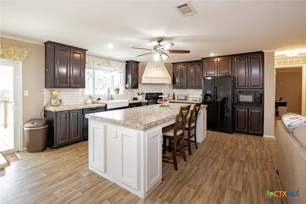 a kitchen with stainless steel appliances a sink stove and refrigerator