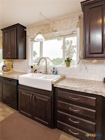 a sink with granite countertop a sink and a mirror