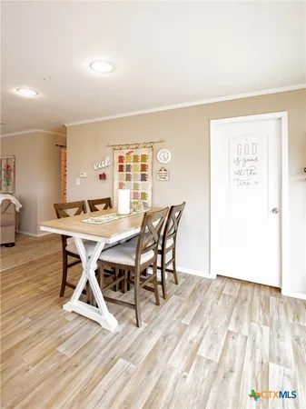 a dining room with a wooden table and chairs