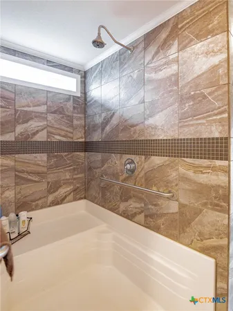 a bathroom with a bathtub and shower