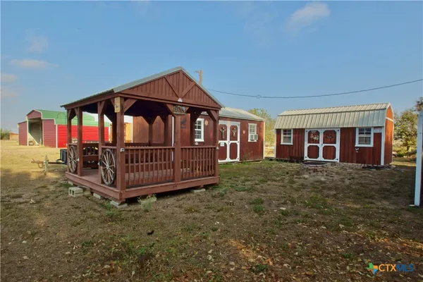 a view of a house with a yard and deck