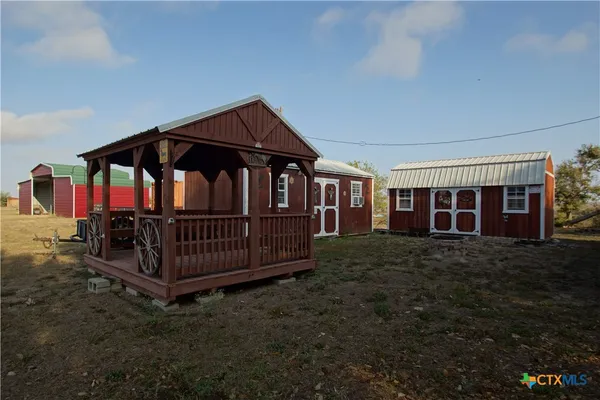 a view of a house with wooden deck