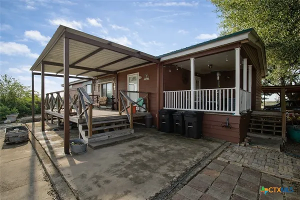 a view of porch with a bench