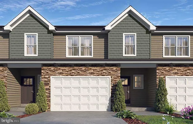 a view of a house with a yard and potted plants