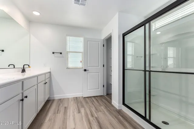 a bathroom with a sink mirror and shower