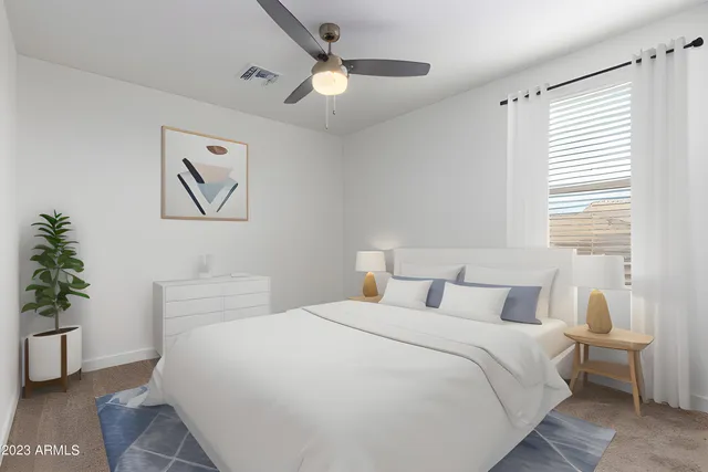 a bedroom with a large bed and a chandelier