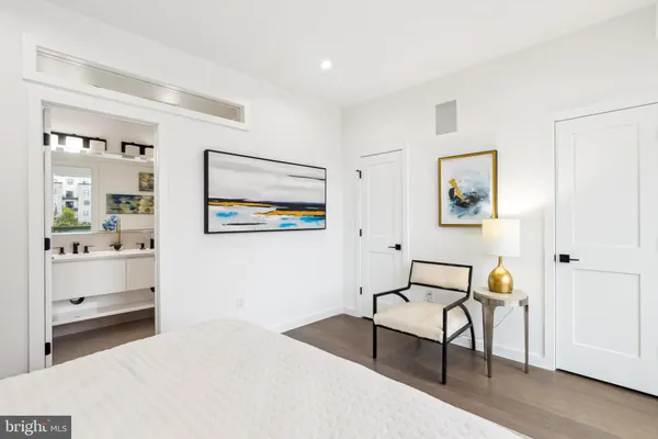 a bedroom with a bed and a painting on the wall
