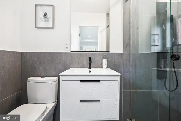 a bathroom with a sink mirror and toilet