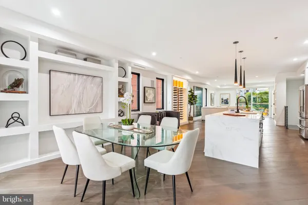 a dining room with furniture a window and wooden floor