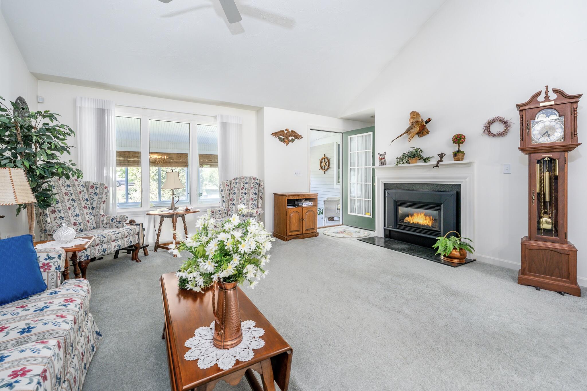7 Masters Court Mashpee, MA 02649 - Photo 12 of 34 a living room with furniture a window and a fireplace