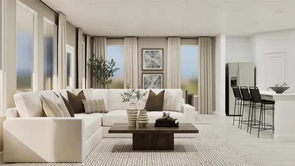 a living room with furniture and large windows